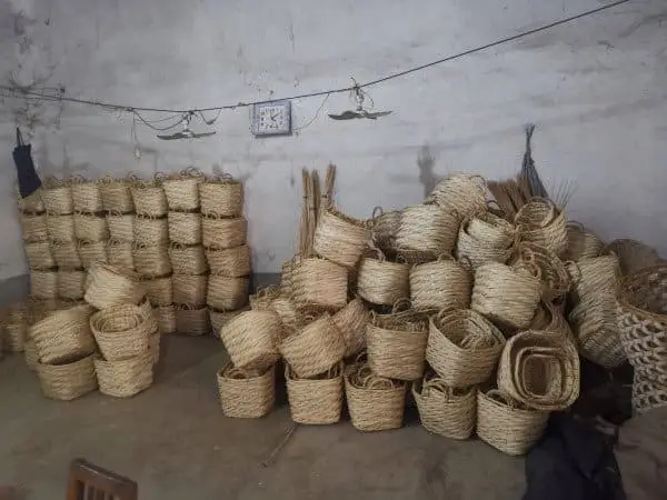 Bundles of woven baskets in factory setting