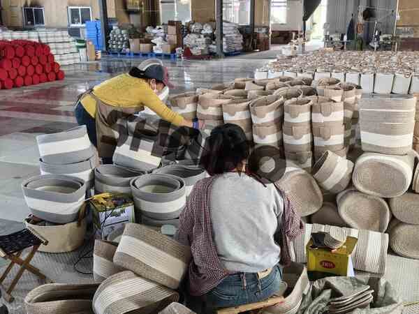 Workers inspecting cotton rope baskets